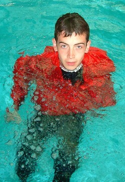 lifesaving treading water wearing an anorak in the pool