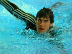 Swim front crawl in tracksuit